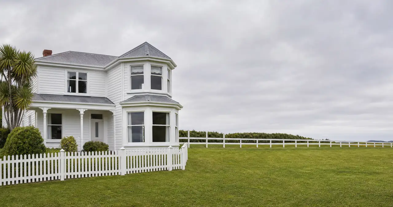 House insurance in New Zealand, on a weatherboard home with its roof, walls and fences insured as one building.